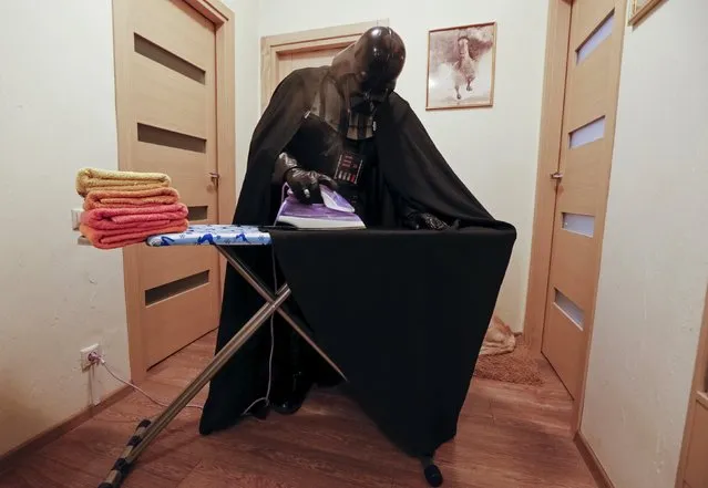 Darth Mykolaiovych Vader, who is dressed as the 'Star Wars' character Darth Vader, poses for a picture as he irons his cloak at his apartments in Odessa, Ukraine, December 2, 2015. (Photo by Valentyn Ogirenko/Reuters)