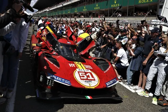 Ferrari AF Corse drivers Antonio Giovinazzi and Alessandro Pier Guidi from Italy and James Calado from Britainis celebrate their victory at the 24-hour Le Mans endurance race in Le Mans, western France, Sunday, June 11, 2023. (Photo by Jeremias Gonzales/AP Photo)