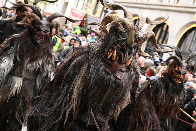 People wearing traditional Krampus costumes and masks attend a traditional parade in Munich, Germany, on December 8, 2024. (Photo by Angelika Warmuth/Reuters)