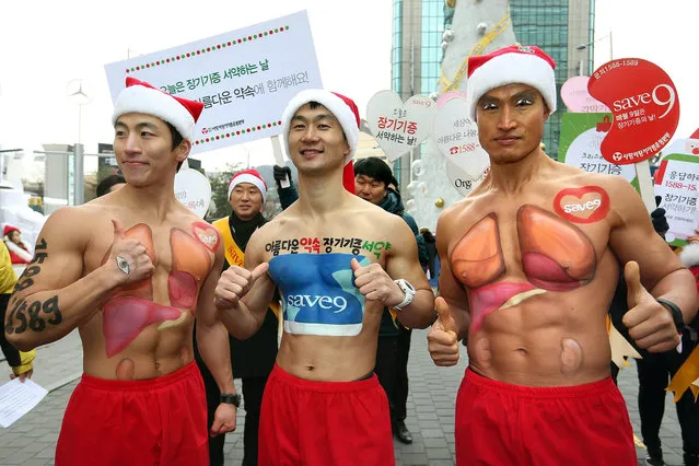 South Korean actor sports trainer Arnold Hong (R) and two others show off their body paint symbolizing life sharing during a campaign organized by the Korean Organ Donor Program, in Seoul, South Korea, 18 December 2015, to promote the movement of sharing healthy organs while alive and donating them after death to save the precious lives of others. (Photo by EPA/Yonhap)