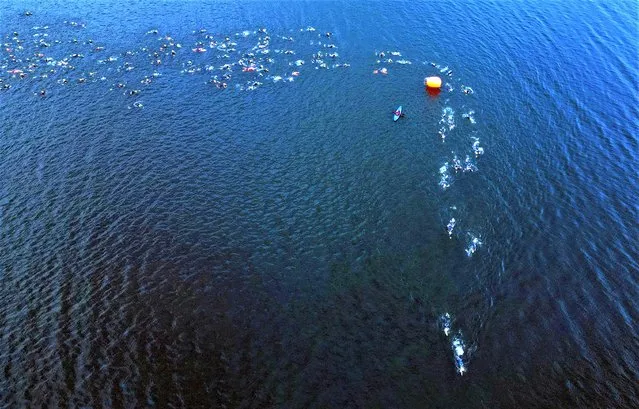 Competitors swim in Lake Windermere during the Windermere Triathlon at Cockshott Point, Bowness-on-Windermere, Britain on July 1, 2023. (Photo by Lee Smith/Reuters)