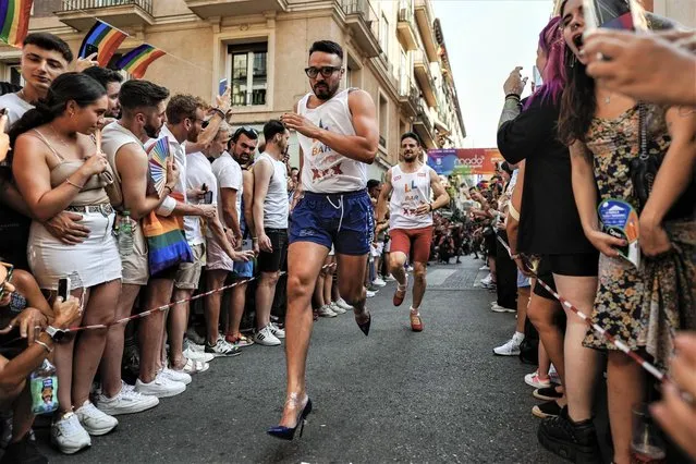 Groups of people participate in the heel race presented by Chumina Power for yet another year during the LGBTI Pride festivities, in the Chueca neighborhood of Madrid, Spain, 29 June 2023. (Photo by Borja Sanchez/EPA/EFE)