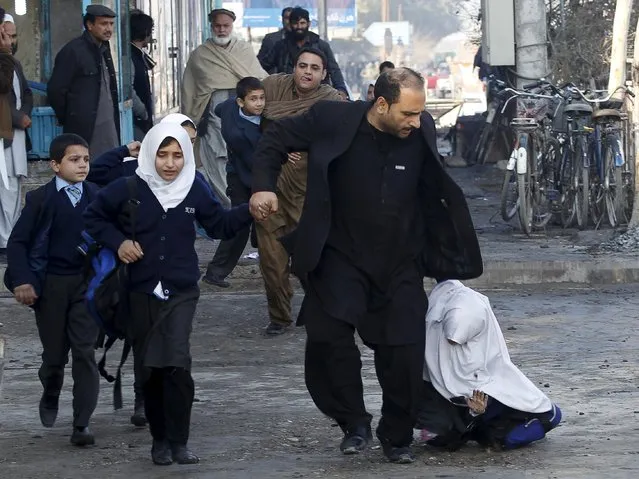 A school girl falls as she and others run after a blast near the Pakistani consulate in Jalalabad, Afghanistan January 13, 2016. (Photo by Reuters/Parwiz)