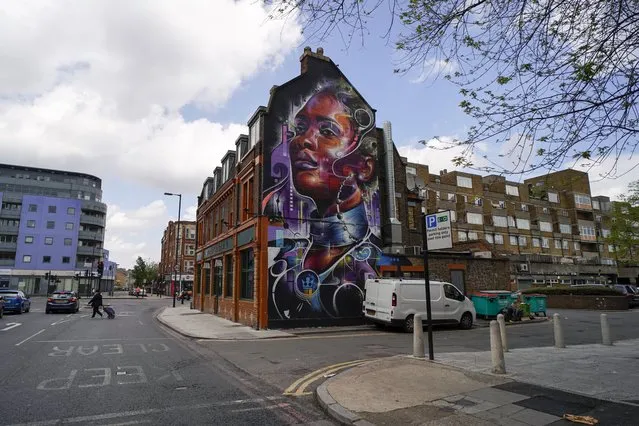 A view of the mural painted facade of the Prince of Peckham pub, on the day it reopens to indoor customers, in London, Monday, May 17, 2021. The coronavirus pandemic has laid siege to Britain's pubs so the latest easing of the lockdown, which allows them to reopen indoors, is hugely welcome. For the Prince of Peckham, a pub in the southeast London district of Peckham, it's a chance to reengage with the local community, including a speed-dating night. It’s the latest innovation by a pub that’s clearly creating a buzz in one of the most diverse communities in London. Around half the local population is Black, so it stands to reason, surely, that one of the few local boozers remaining should seek as wide a clientele as possible. (Photo by Alberto Pezzali/AP Photo)