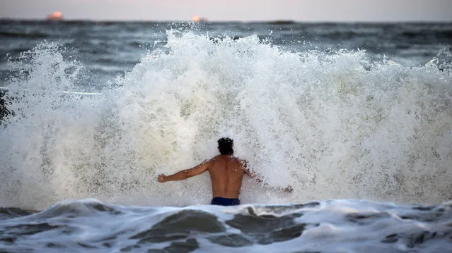 Body surfer Andrew Vanotteren, of Savannah, Ga., crashes into waves from Hurricane Florence, Wednesday, September 12, 2018, on the south beach of Tybee Island, Ga. Vanotteren and his friend Bailey Gaddis said the waves have gotten bigger and better every evening as the storm approaches. (Photo by Stephen B. Morton/AP Photo)