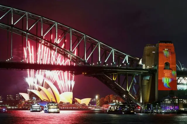 Fireworks explode as the Sydney Opera House and Sydney Harbour Bridge are illuminated with projections and lights at the start of the Vivid Sydney festival in Sydney on May 26, 2023. (Photo by David Gray/AFP Photo)