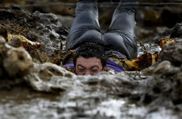 A participant competes in the “Farinato Race” winter extreme run competition in Gijon, northern Spain, January 31, 2016. (Photo by Eloy Alonso/Reuters)