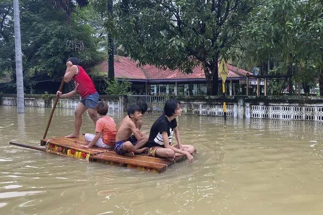 Local residents use a raft to pass a flooded road in Bago, about 80 kilometers (50 miles) northeast of Yangon, Myanmar, Monday, October 9, 2023. Flooding triggered by heavy monsoon rains in Myanmar’s southern areas has displaced more than 10,000 people and disrupted traffic on the rail lines that connect the country’s biggest cities, officials and state-run media said Monday. (Photo by Thein Zaw/AP Photo)