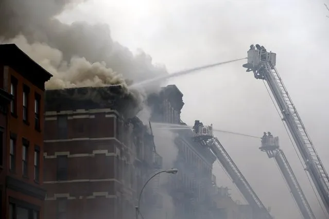 New York City Fire Department firefighters battle fire at the site of a residential apartment building in New York City's East Village neighborhood March 26, 2015. (Photo by Mike Segar/Reuters)