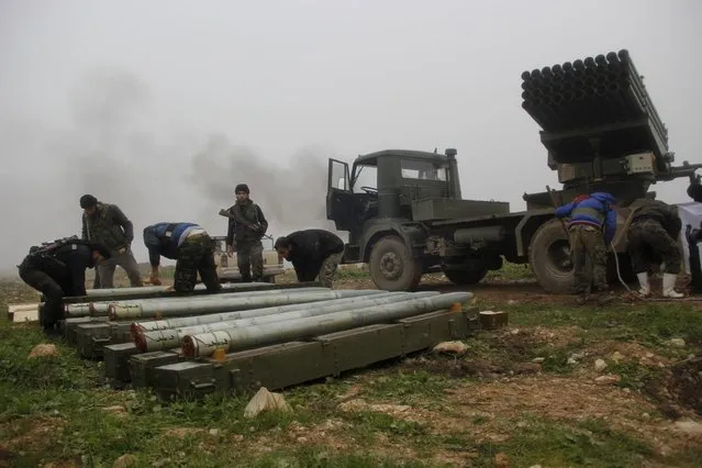 Al-Furqan brigade fighters, part of the Free Syrian Army, prepare Grad rockets before firing them towards forces loyal to Syria's president Bashar Al-Assad located in Mork town, Hama countryside, from Khan Sheikoun, Idlib countryside January 17, 2015. (Photo by Mohamad Bayoush/Reuters)