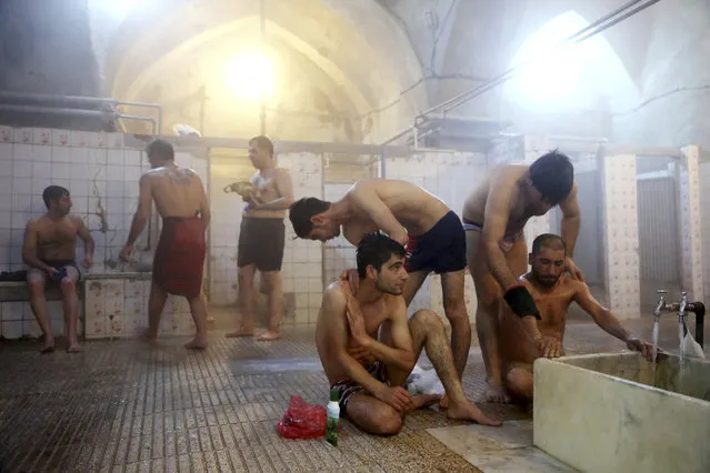 In this Friday, January 9, 2015 photo, a group of workers bathe at the Ghebleh public bathhouse, in Tehran, Iran. (Photo by Ebrahim Noroozi/AP Photo)