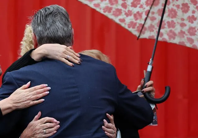 Well-wishers embrace Kier Starmer, leader of Britain's Labour Party, as he attends a by-election victory event for Sarah Edwards, newly elected MP for Tamworth, at Tamworth football stadium, Tamworth in central Britain on October 20, 2023. (Photo by Toby Melville/Reuters)