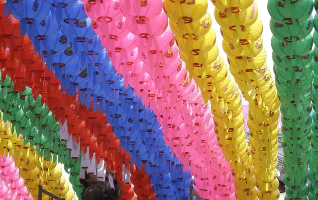 In this Monday, February 4, 2019, photo, a worker attaches a name tag of a Buddhist who made a donation of a lantern to celebrate the upcoming Lunar New Year at the Bongeun Buddhist temple in Seoul, South Korea. Lunar New Year is one of the biggest holidays celebrated in South Korea. (Photo by Ahn Young-joon/AP Photo)