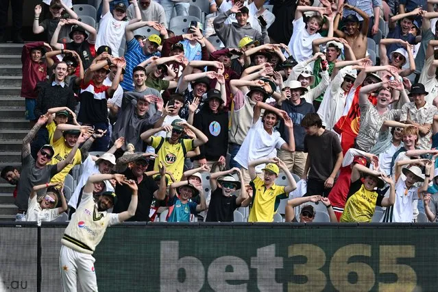 Spectators mimic the movements of Hasan Ali of Pakistan during day three of the Second Test Match between Australia and Pakistan at Melbourne Cricket Ground on December 28, 2023 in Melbourne, Australia. (Photo by Quinn Rooney/Getty Images)