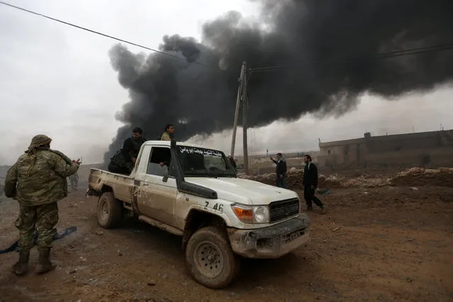 Smoke rises after a car bomb explosion in Jub al Barazi east of the northern Syrian town of al-Bab, Syria January 15, 2017. (Photo by Khalil Ashawi/Reuters)
