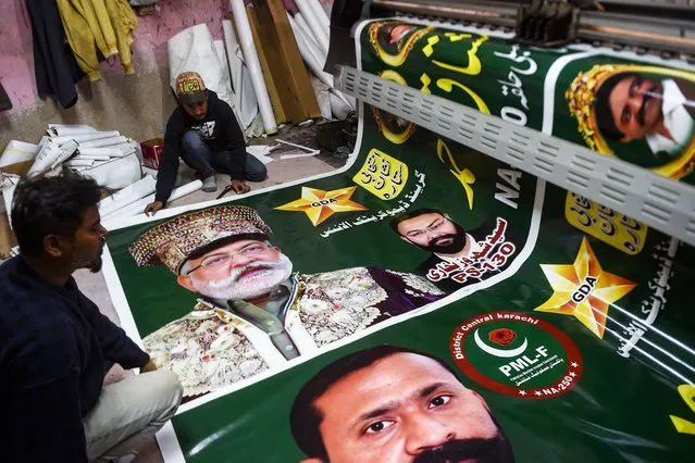 Workers print election posters of Pakistan Muslim League – Functional (PML-F) party at a printing press in Karachi on January 11, 2024, ahead of the country’s upcoming general elections. (Photo by Rizwan Tabassum/AFP Photo)
