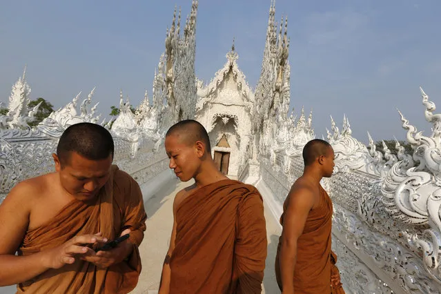Buddhist monks take a tour at Wat Rong Khun also know as the White Temple designed by Thai visual artist Chalermchai Kositpipat in Chiang Rai Province, Thailand March 4, 2016. (Photo by Jorge Silva/Reuters)