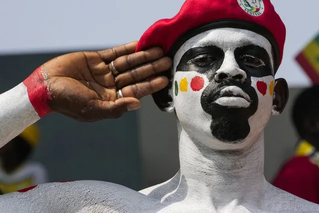 A Senegal supporter salutes as he cheers with others at the stand prior the African Cup of Nations Group C soccer match between Senegal and Gambia at the Charles Konan Banny stadium in Yamoussoukro, Ivory Coast, Monday, January 15, 2024. (Photo by Sunday Alamba/AP Photo)