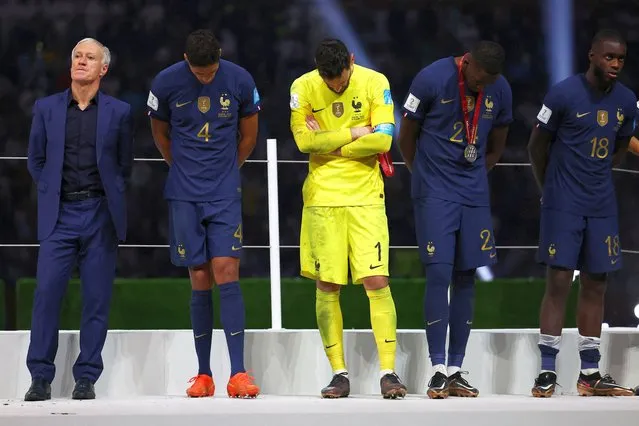 France coach Didier Deschamps, Raphael Varane, Hugo Lloris, Ibrahima Konate and Dayot Upamecano look dejected after they are awarded with their runners up medals at the Lusail Stadium in Lusail, Qatar on December 18, 2022. (Photo by Kai Pfaffenbach/Reuters)