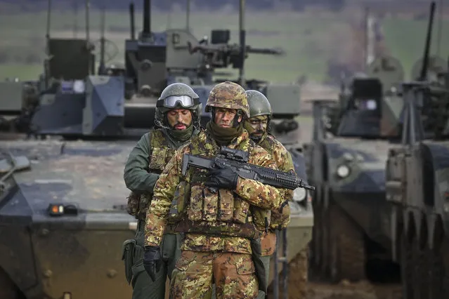 Italian Army troops, take part in the joint military exercise “Strike Back” at the Novo Selo military ground, northwestern Bulgaria, on December 14, 2022. The Multinational Battlegroup with framework country Italy, of which Bulgaria is the host country, demonstrates full operational capabilities during the “Strike Back” joint exercises with participation of personnel from Italy, Bulgaria, Albania, Greece, the Republic of North Macedonia and the United States. (Photo by Nikolay Doychinov/AFP Photo)