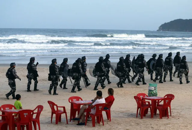 Riot police patrol the Santinho beach next the Costao do Santinho hotel ahead of the 2014 FIFA World Cup in Florianopolis, Santa Catarina state, February 19, 2014. (Photo by Sergio Moraes/Reuters)