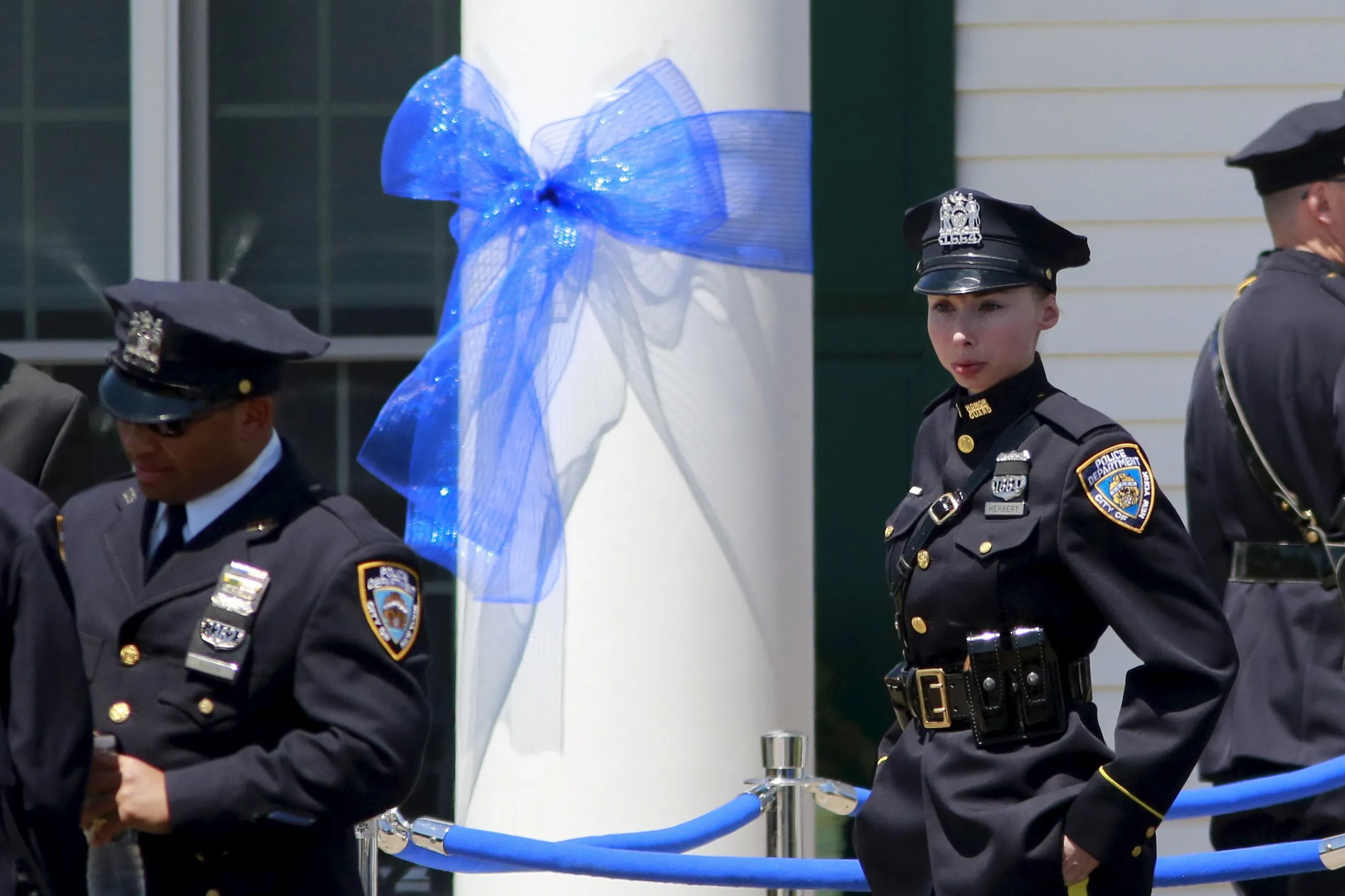NYPD police officers stand outside the wake of officer Brian Moore at the F...