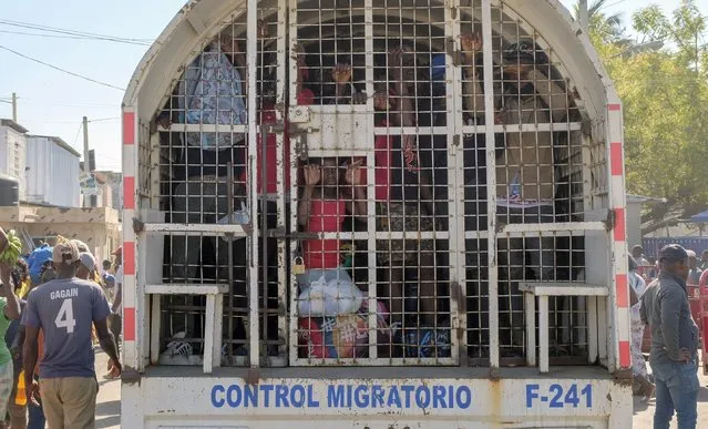 People who were detained for deportation to Haiti stand inside a police truck on the border bridge that connects Dajabon, Dominican Republic with Haiti, Monday, March 18, 2024. (Photo by Ricardo Hernandez/AP Photo)