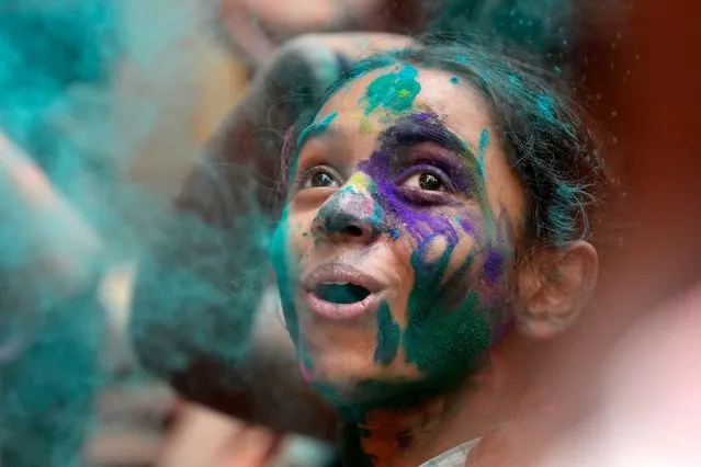 A specially abled child participates in an early celebration of Holi, the Hindu festival of colors, at her school in Mumbai, India, Friday, March 22, 2024. (Photo by Rajanish Kakade/AP Photo)