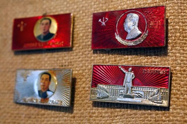 A badge featuring a statue of former North Korean leader Kim Il Sung (lower R), is displayed in the glass case of Thomas Hui at his apartment in Hong Kong, China April 11, 2016. (Photo by Bobby Yip/Reuters)