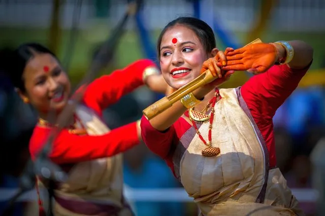 Assamese girls wearing traditional Mekhela Chadar perform the Bihu folk dance during the Rongali Bihu festival, organized by All Assam Students Union in Guwahati, capital of the north eastern state of Assam, India, Saturday, April 13, 2024. (Photo by Anupam Nath/AP Photo)