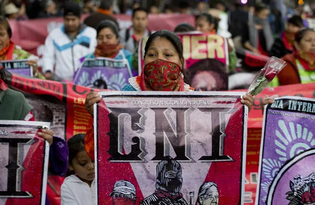 Women from the National Indigenous Congress march during a demonstration marking International Women's Day in Mexico City, Wednesday, March 8, 2017. Many women demonstrated by staying home from work, joining rallies or wearing red Wednesday as International Women's Day was observed with a multitude of events around the world. (Photo by Eduardo Verdugo/AP Photo)