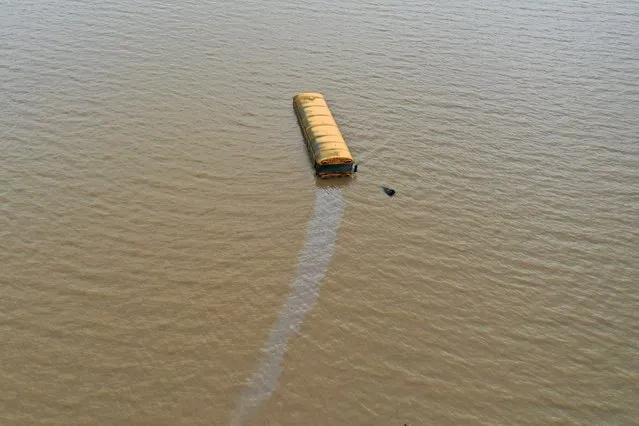 A schoolbus is submerged in floodwaters due to heavy rain in Adna, Washington, U.S. January 8, 2022. Picture taken with a drone. (Photo by Drone Base/Reuters)