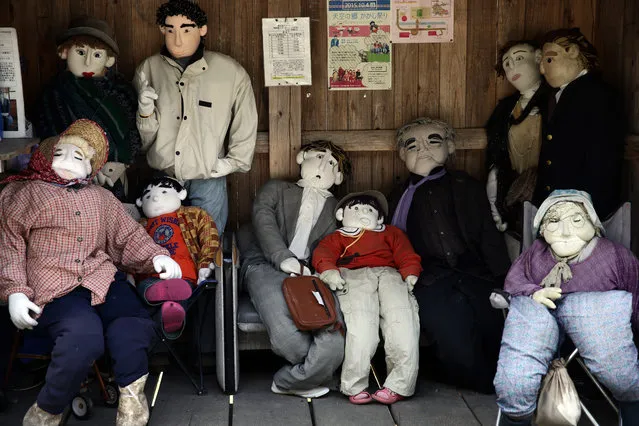Hand-made dolls sit in a shelter as others are placed around the village by local resident Tsukimi Ayano to replace the dwindling local population on April 22, 2016 in Nagoro village, in Miyoshi, Japan. Likely more dolls than the number of inhabitants are placed around the village called “Kakashi No Sato”. According to Japan's Statistic Bureau, the percentage of people over 65 years old in Japan is 26.8% while that of the the world is 8.2%. The National Institute of Population and Social Security Research in Tokyo, Japan's population, now around 128 million, is expected to dip below 100 million in 2046. (Photo by Carl Court/Getty Images)