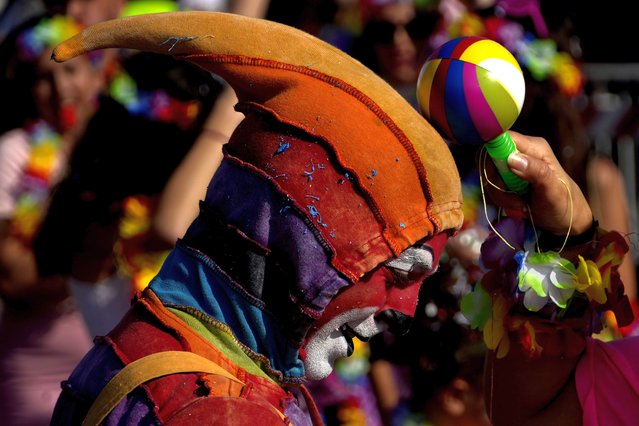 A man wearing carnival costume takes part in a traditional carnival parade in the southeast small town of Paralimni, Cyprus, on Sunday, February 26, 2023. The parade on the eve of the start of Orthodox Lent, is back in full force after being suspended for the last two years because of restrictions regarding the COVID-19 pandemic. (Photo by Petros Karadjias/AP Photo)