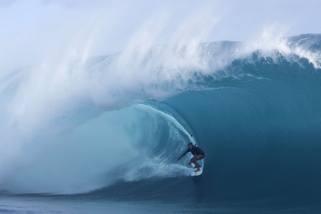 Tikanui Smith of Tahiti rides a wave while practicing for the WSL event and the 2024 Olympics at the world famous Teahupo'o in Tahiti, French Polynesia on May 14, 2024. (Photo by Brian Bielmann/AFP Photo)