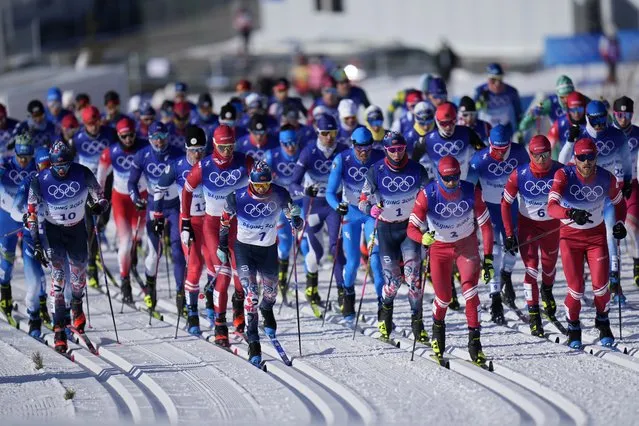 Skiers compete during the men's 15km + 15km skiathlon cross-country skiing competition at the 2022 Winter Olympics, Sunday, February 6, 2022, in Zhangjiakou, China. (Photo by Alessandra Tarantino/AP Photo)