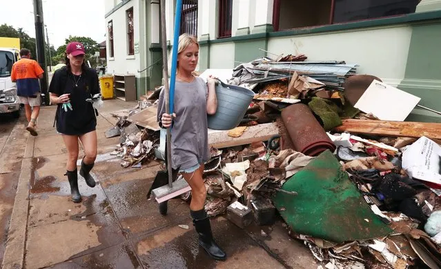 Residents help with cleanup efforts after floods in New South Wales, Lismore, Australia on March 4, 2022. (Photo by Jason O’Brien/EPA)
