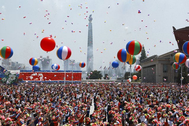 North Korea's people attend the official welcome ceremony with Russian President Vladimir Putin and North Korea's leader Kim Jong Un in the Kim Il Sung Square in Pyongyang, North Korea, on Wednesday, June 19, 2024. (Photo by Vladimir Smirnov, Sputnik, Kremlin Pool Photo via AP Photo)