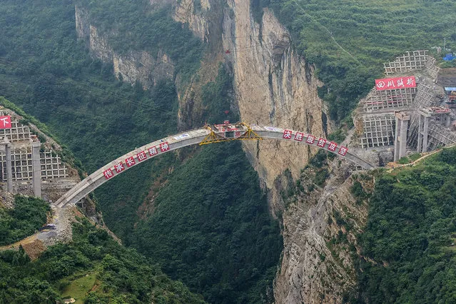 This photo taken on July 7, 2019 shows the main structure of the Jimingsansheng Bridge as it is joined together in Xuyong county in Luzhou City in China's southwestern Sichuan province. The bridge joins southwest China's Yunnan, Guizhou and Sichuan provinces. (Photo by AFP Photo/China Stringer Network)