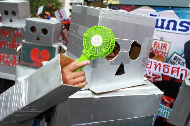 Protesters attend a rally dressed up as robots during a march on International Workers' Day on May 1, 2017. Thai workers called for better-guaranteed labour rights on Monday as they participated in a rally organized by various labour unions in downtown Bangkok. (Photo by Vichan Poti/Pacific Press via ZUMA Wire)