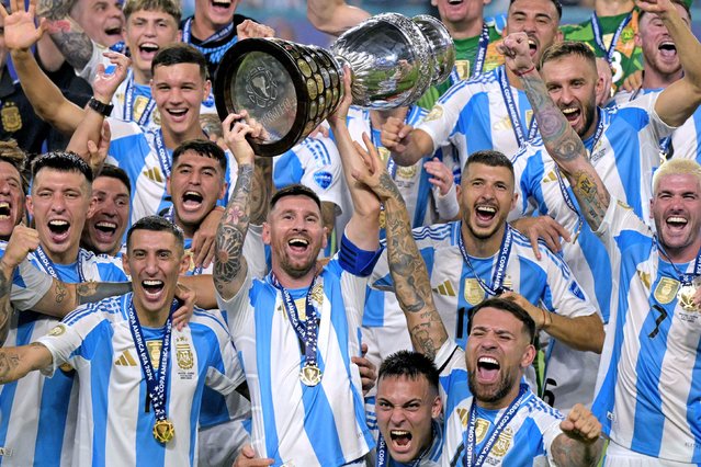 Argentina captain Lionel Messi lifts the trophy as he and his teammates celebrate their Copa América title on Sunday, July 14, 2024. Argentina defeated Colombia 1-0 in the tournament final, which was played in Miami Gardens, Florida. Argentina has now won the Copa América a record 16 times. (Phoot by Juan Mabromata/AFP Photo)