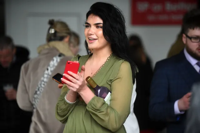 Racegoers attend the opening day of the Grand National Festival horse race meeting at Aintree Racecourse in Liverpool, north west England on April 7, 2022. (Photo by John Mather/Image View)