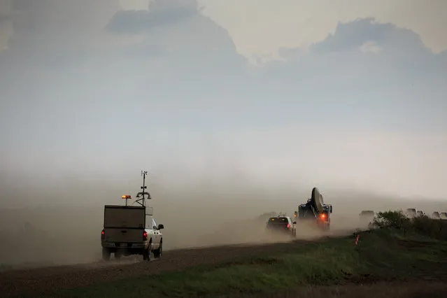 A tornado scout vehicle and the Doppler on Wheels (DOW) vehicle chase after a supercell thunderstorm during a tornado research mission, May 10, 2017 in Olustee, Oklahoma. (Photo by Drew Angerer/Getty Images)