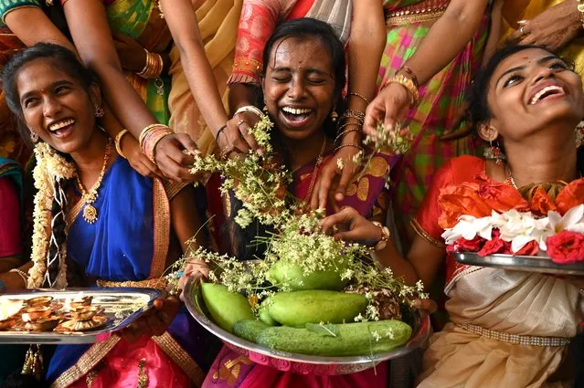 Students wearing traditional costumes celebrate on the eve of “Ugadi” festival, or new year's day as per the Hindu lunisolar calendar, in Chennai on April 1, 2022. (Photo by Arun Sankar/AFP Photo)