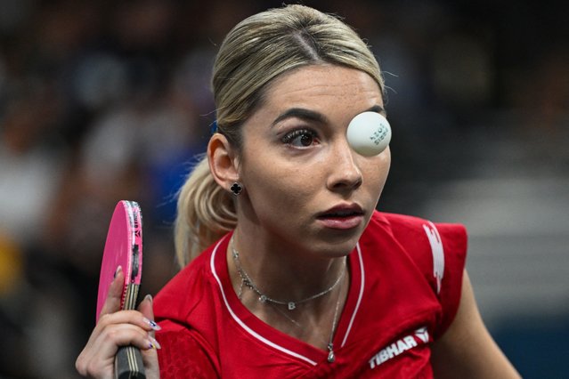 Romania's Bernadette Szocs eyes the ball during her women's table tennis doubles match in the team round of 16 between Romania and India at the Paris 2024 Olympic Games at the South Paris Arena in Paris on August 5, 2024. (Photo by Jung Yeon-Je/AFP Photo)