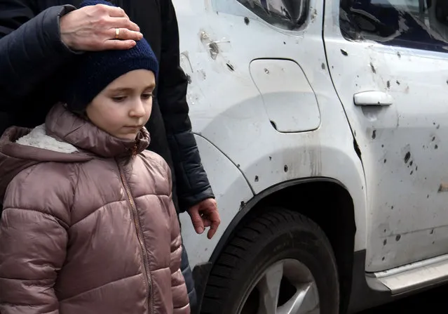 Viktoria Shekhovtsova and daughter Elizaveta, 6 years old with her parents Grigoriy, 68 and Zoya, 72 arrive in their battered car at Zaporizhia, Ukraine on March 30, 2022. Displaced people fleeing desperately brutal conditions of the Russian invasion of Mariupol and other besieged cities evacuate through Zaporizhzhya. Their house in Mariupol was hit with a rocket they were forced to shelter in a neighboring house for 3 weeks before escaping. (Photo by Carol Guzy/ZUMA Press Wire/Rex Features/Shutterstock)