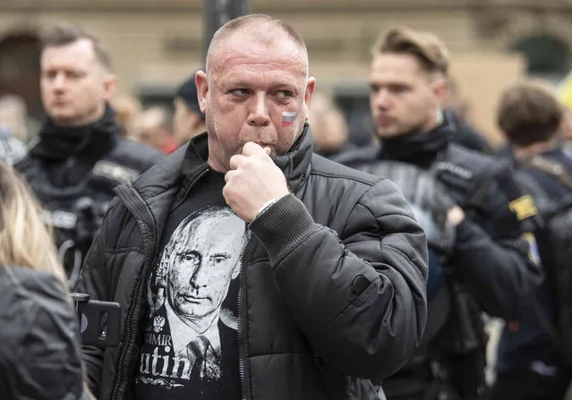A man wears a T-shirt depicting Russian President Putin at the pro-Russian demonstration in Frankfurt, Germany, Sunday, April 10, 2022. The police accompanied the rally with several hundred units. The demonstration was announced under the slogan “Against agitation and discrimination of Russian-speaking fellow citizens/Against war – for peace”. (Photo by Boris Roessler/dpa via AP)
