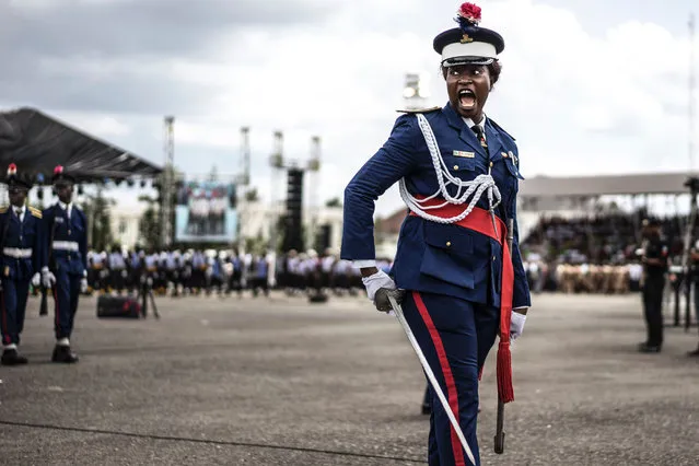 A Nigerian policewoman gives an order as she marches in front of authorities and members of the public during a Democracy Day parade on May 29, 2017 in Freedom Square in Owerri. Democracy Day celebrates the end of military rules in Nigeria in May of 1999. (Photo by Marco Longari/AFP Photo)