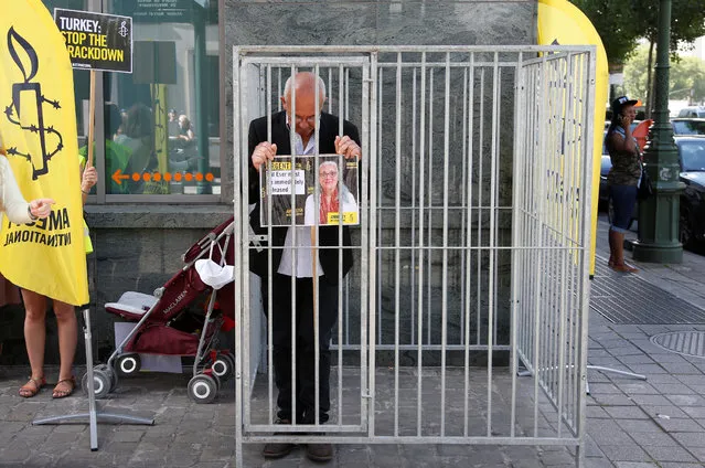 Amnesty International Belgium's Director Philippe Hensmans poses in a cage in front of the Turkish embassy in Brussels to protest against the detention of his Turkish counterpart Idil Eser, Belgium, July 10, 2017. (Photo by Francois Lenoir/Reuters)