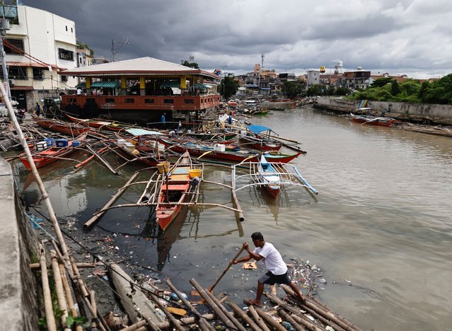 A fisherman secures a makeshift raft in anticipation of an approaching tropical storm in Bacoor city, Cavite province, about 30 kilometers south-east of Manila, Philippines, 13 September 2024. The state weather agency of the Philippines forecasted on 13 September heavy to intense rainfall due to the southwest monsoon enhanced by Tropical Storm Bebinca as it moves northwestward and warned residents to take precautionary measures due to possible flash floods in low-lying areas and landslides in mountainous villages. (Photo by Francis R. Malasig/EPA/EFE)